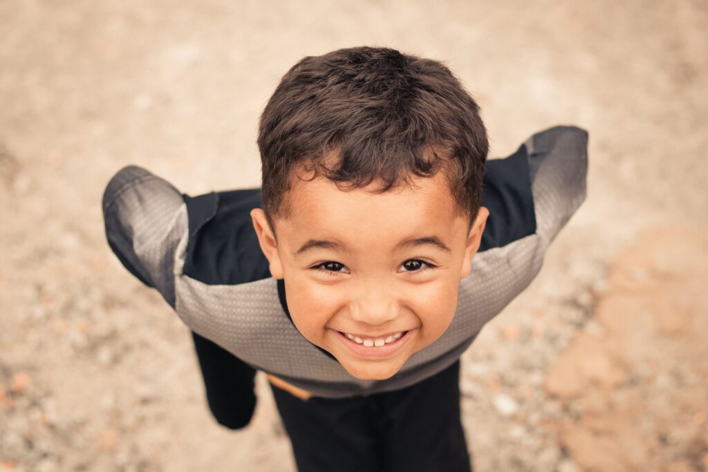 pexels-photo-6357426-6357426 From above of joyful little Hispanic kid with hands on waist looking at camera